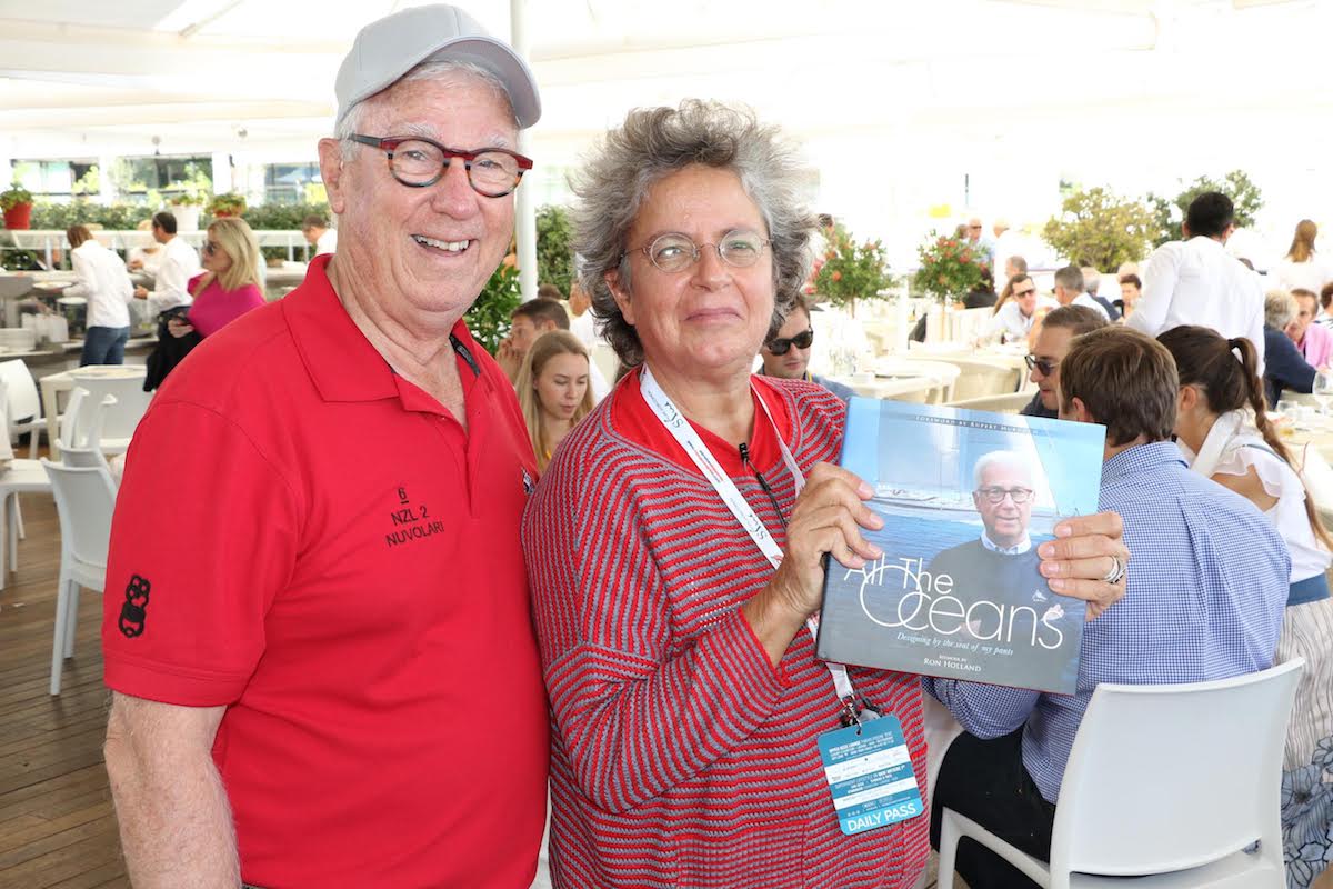Monaco Yacht Show with Ron Holland and Sophie Pigozzi holding Ron Holland's memoir "All The Oceans"