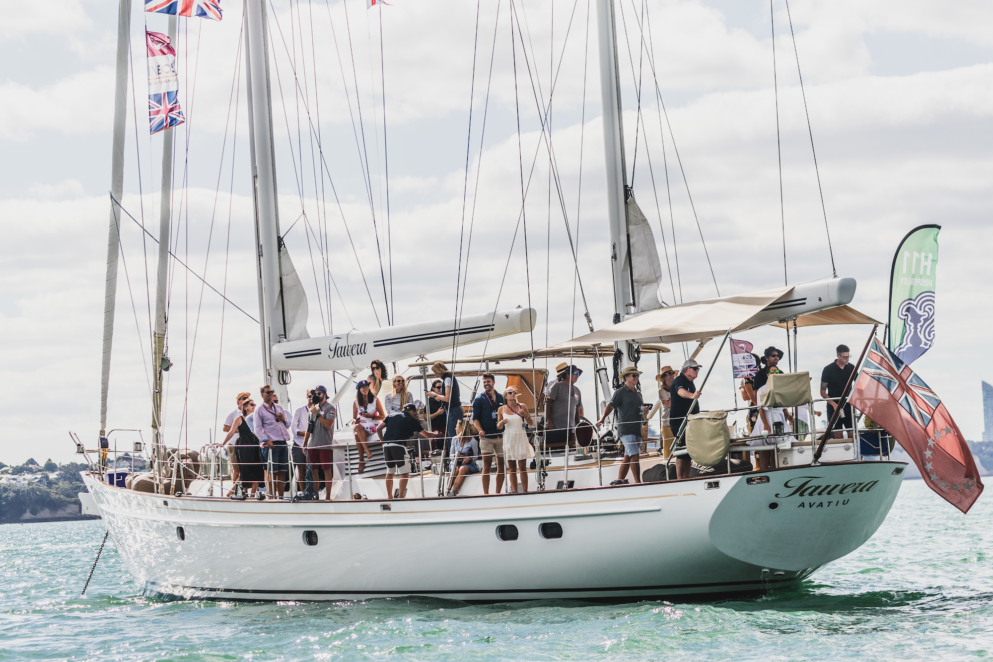 Sailing yacht Tawera at the Prada Cup January 2021 seen on the waters of Waitemata Harbour, Auckland, New Zealand with celebration aboard the deck of this racing yacht